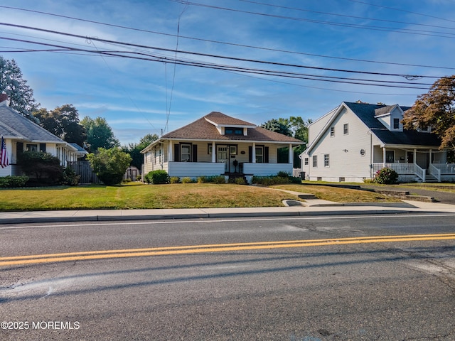 54 Wall St, West Long Branch, NJ 07764 - bungalow-style house featuring covered porch and a front lawn