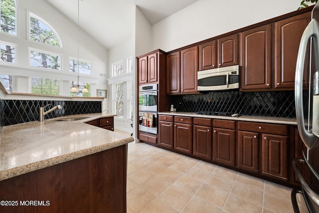 38 Point Pleasant Ln, Waretown, NJ 08758 - kitchen featuring appliances with stainless steel finishes, high vaulted ceiling, decorative backsplash, a sink, and light tile patterned floors