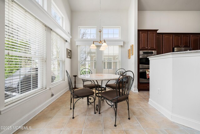 38 Point Pleasant Ln, Waretown, NJ 08758 - dining area featuring healthy amount of natural light, light tile patterned floors, baseboards, and a high ceiling