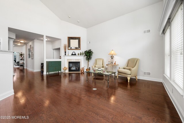 38 Point Pleasant Ln, Waretown, NJ 08758 - sitting room featuring a fireplace, plenty of natural light, high vaulted ceiling, wood finished floors, and baseboards
