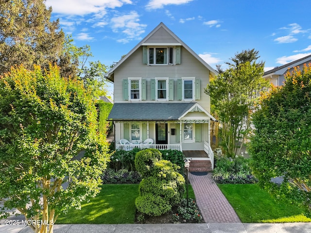 85 Virginia Ave, Manasquan, NJ 08736 - view of front of property featuring a porch and a front lawn