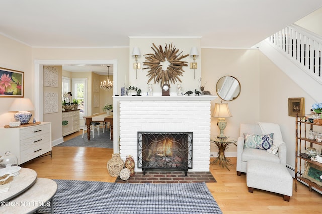 85 Virginia Ave, Manasquan, NJ 08736 - living area with wood finished floors, a chandelier, stairway, baseboards, and crown molding