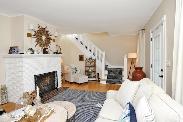 85 Virginia Ave, Manasquan, NJ 08736 - living room with stairway, wood finished floors, a brick fireplace, and ornamental molding