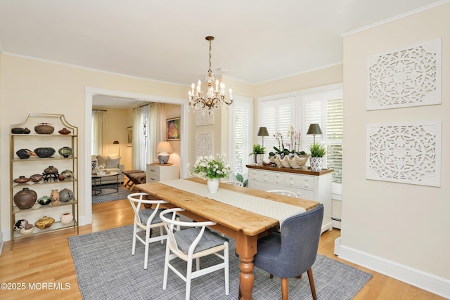85 Virginia Ave, Manasquan, NJ 08736 - dining space featuring light wood-style flooring, a chandelier, ornamental molding, a baseboard radiator, and baseboards