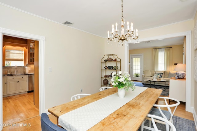 85 Virginia Ave, Manasquan, NJ 08736 - dining space featuring light wood finished floors, a chandelier, and crown molding