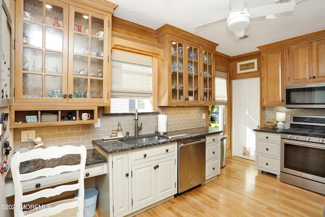 85 Virginia Ave, Manasquan, NJ 08736 - kitchen with stainless steel appliances, a sink, tasteful backsplash, a ceiling fan, and glass insert cabinets