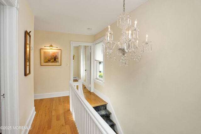 85 Virginia Ave, Manasquan, NJ 08736 - hall with a chandelier, light wood-style floors, baseboards, baseboard heating, and stairway