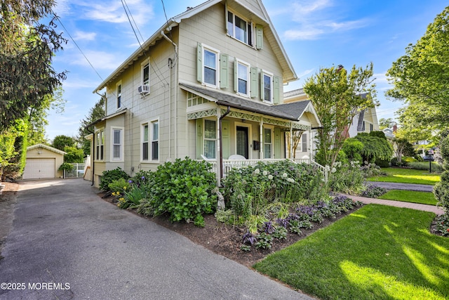 85 Virginia Ave, Manasquan, NJ 08736 - view of front of home with covered porch, a garage, an outdoor structure, and a front lawn