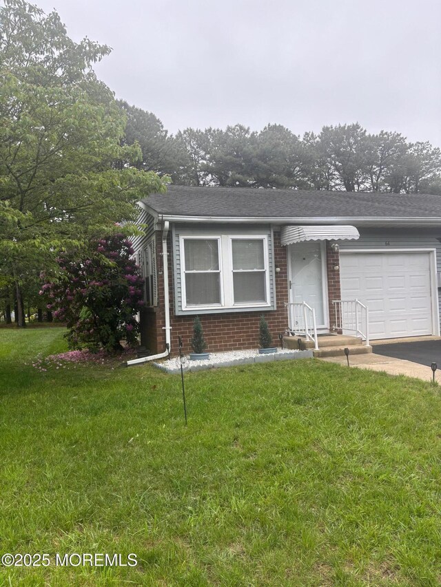 6 Ardmore St Unit A, Whiting, NJ 08759 - view of front of home featuring brick siding, an attached garage, concrete driveway, and a front yard