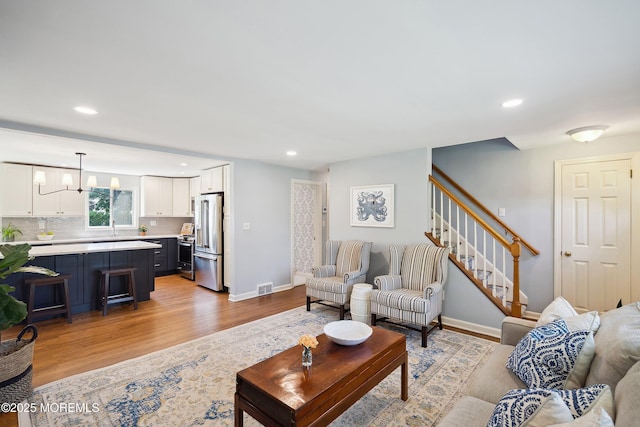 177 Cambridge Ave, Fair Haven, NJ 07704 - living room with light wood finished floors, stairway, and recessed lighting