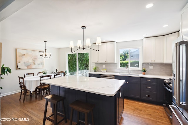 177 Cambridge Ave, Fair Haven, NJ 07704 - kitchen featuring a chandelier, tasteful backsplash, a kitchen island, light wood-style flooring, and recessed lighting