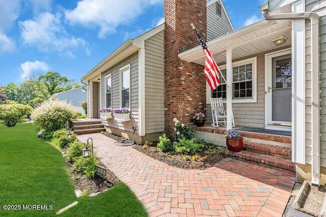 1304 Lenape Trl, Manasquan, NJ 08736 - entrance to property with a porch, a chimney, and a lawn