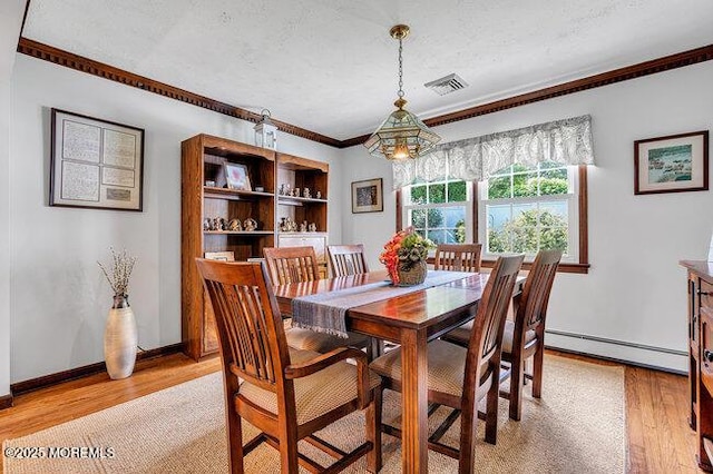 1304 Lenape Trl, Manasquan, NJ 08736 - dining space with a baseboard heating unit, crown molding, light wood-style floors, a chandelier, and baseboards