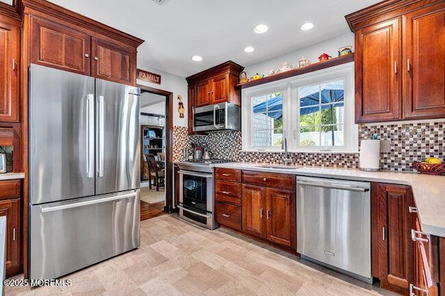 1304 Lenape Trl, Manasquan, NJ 08736 - kitchen featuring appliances with stainless steel finishes, a sink, light countertops, tasteful backsplash, and recessed lighting