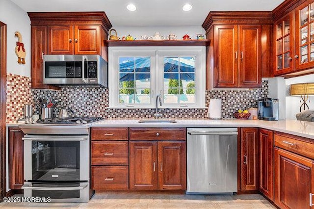 1304 Lenape Trl, Manasquan, NJ 08736 - kitchen with stainless steel appliances, a sink, light countertops, decorative backsplash, and glass insert cabinets