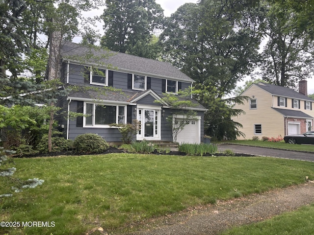 76 Ridge Rd, Fair Haven, NJ 07704 - view of front of home with a front yard, asphalt driveway, roof with shingles, and an attached garage
