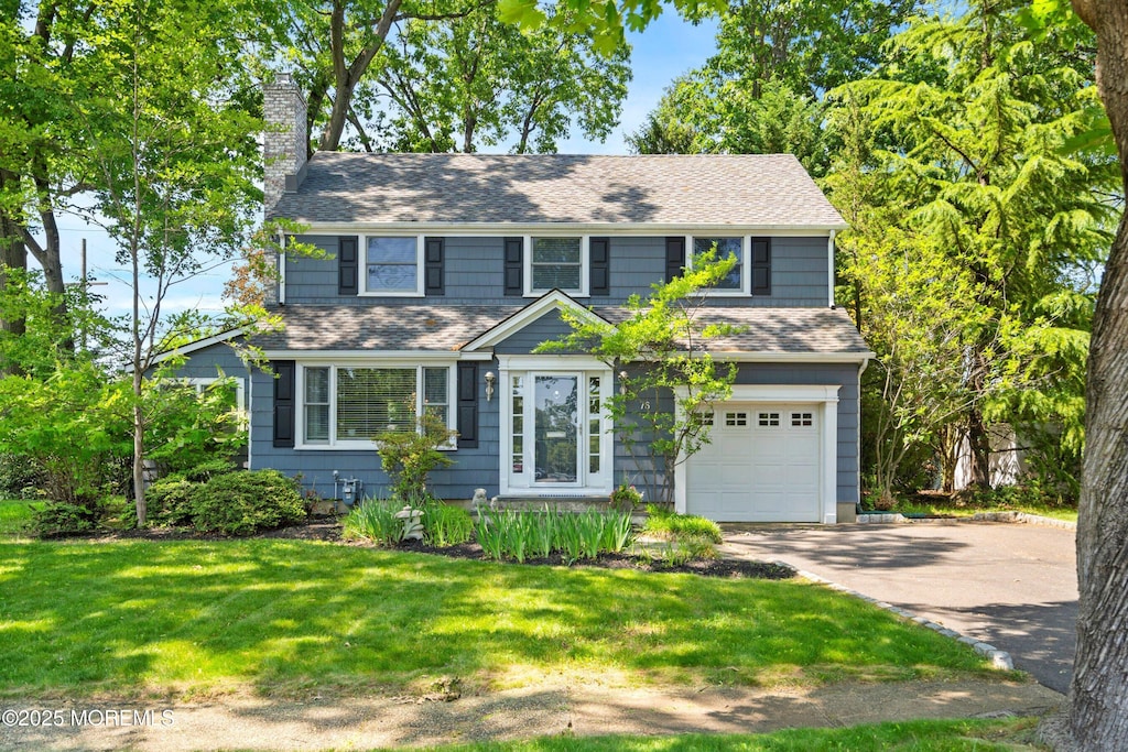 76 Ridge Rd, Fair Haven, NJ 07704 - colonial home featuring a garage, a chimney, concrete driveway, a shingled roof, and a front yard