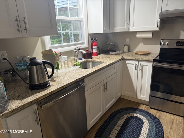 2 Cottage Ct Unit A, Whiting, NJ 08759 - kitchen with stainless steel appliances, under cabinet range hood, white cabinetry, dark wood-style floors, and a sink