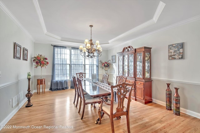 11 Elkridge Way, Manalapan, NJ 07726 - dining area with a raised ceiling, a chandelier, light wood-type flooring, ornamental molding, and baseboards