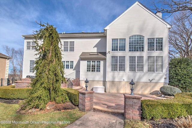 11 Elkridge Way, Manalapan, NJ 07726 - back of house featuring a chimney and a patio area