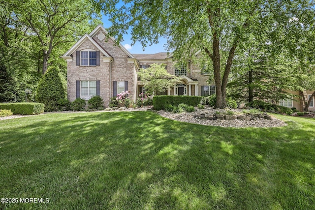 11 Elkridge Way, Manalapan, NJ 07726 - traditional home with a front yard and brick siding
