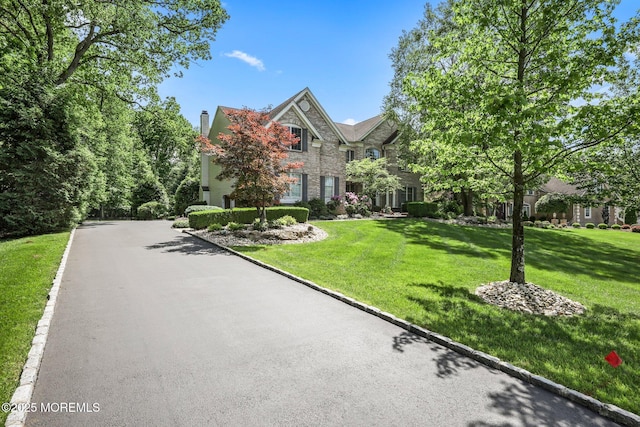 11 Elkridge Way, Manalapan, NJ 07726 - view of front of home with stone siding and a front yard