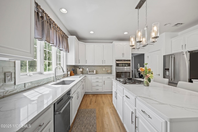 11 Elkridge Way, Manalapan, NJ 07726 - kitchen featuring appliances with stainless steel finishes, a sink, a chandelier, recessed lighting, and white cabinetry