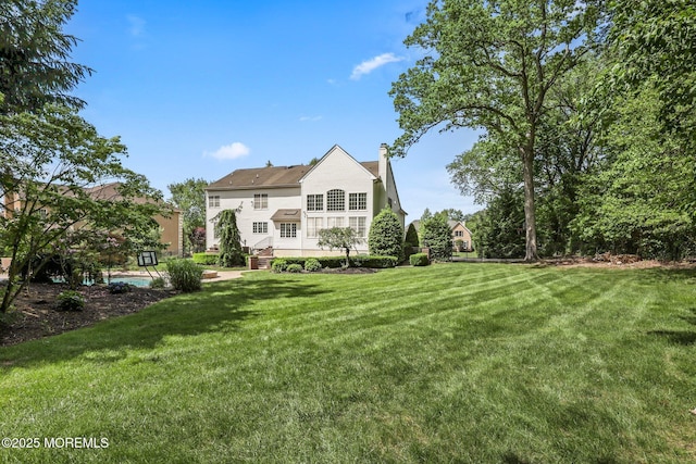 11 Elkridge Way, Manalapan, NJ 07726 - back of property featuring a chimney and a yard