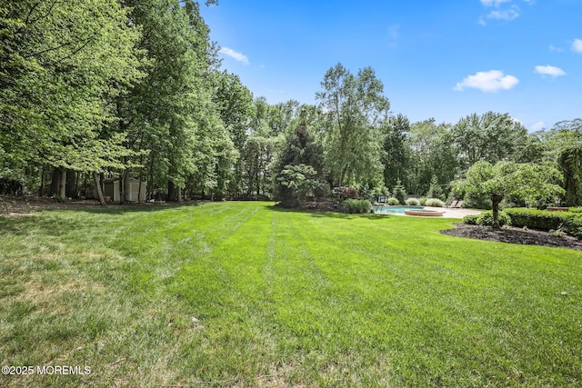 11 Elkridge Way, Manalapan, NJ 07726 - view of grassy yard with an outdoor pool