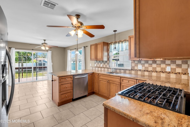 9 Fullerton Dr, Brick, NJ 08723 - kitchen featuring stainless steel dishwasher, stovetop, a peninsula, backsplash, and hanging light fixtures