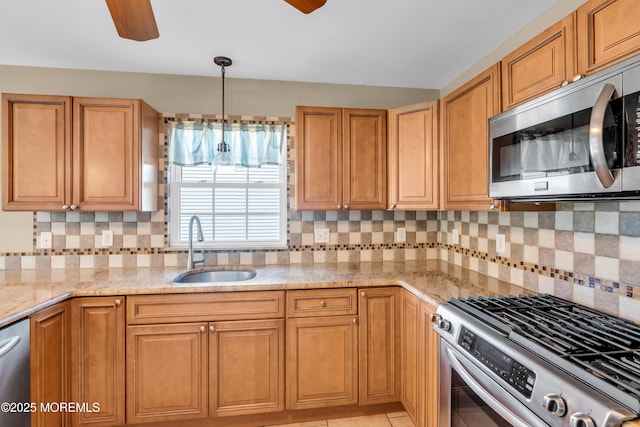9 Fullerton Dr, Brick, NJ 08723 - kitchen with appliances with stainless steel finishes, a sink, a ceiling fan, light stone countertops, and decorative backsplash