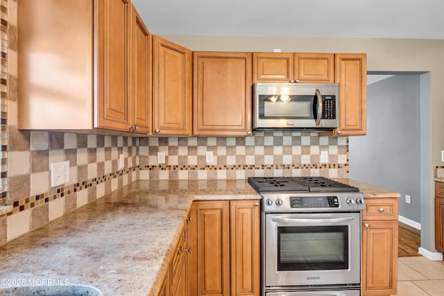 9 Fullerton Dr, Brick, NJ 08723 - kitchen with stainless steel appliances, tasteful backsplash, light stone countertops, and baseboards