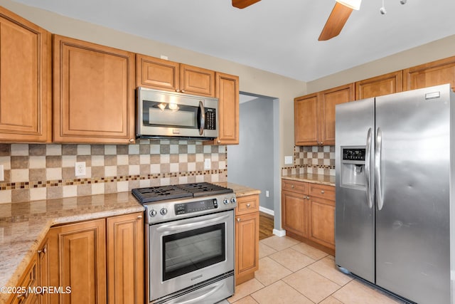 9 Fullerton Dr, Brick, NJ 08723 - kitchen featuring appliances with stainless steel finishes, ceiling fan, light tile patterned flooring, tasteful backsplash, and light stone countertops