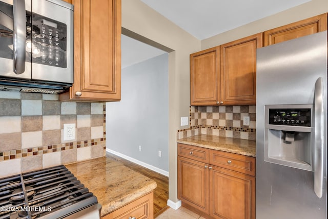 9 Fullerton Dr, Brick, NJ 08723 - kitchen featuring appliances with stainless steel finishes, decorative backsplash, light stone counters, and baseboards