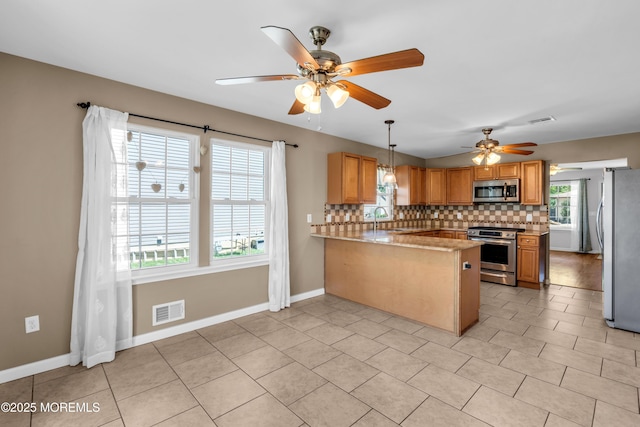 9 Fullerton Dr, Brick, NJ 08723 - kitchen with stainless steel appliances, ceiling fan, a peninsula, backsplash, and baseboards
