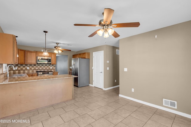9 Fullerton Dr, Brick, NJ 08723 - kitchen featuring stainless steel appliances, a sink, ceiling fan, decorative backsplash, and baseboards