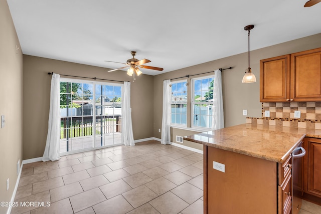9 Fullerton Dr, Brick, NJ 08723 - kitchen with ceiling fan, a peninsula, backsplash, baseboards, and brown cabinets