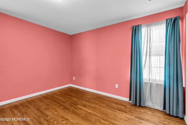 9 Fullerton Dr, Brick, NJ 08723 - empty room with wood finished floors, healthy amount of natural light, and baseboards
