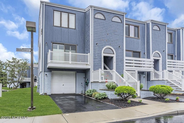 3 Black Pine Ln, Brielle, NJ 08730 - view of property with asphalt driveway, a garage, a front lawn, and a balcony