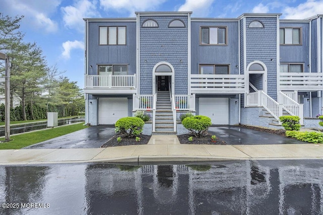 3 Black Pine Ln, Brielle, NJ 08730 - view of property with stairway, an attached garage, driveway, and a water view