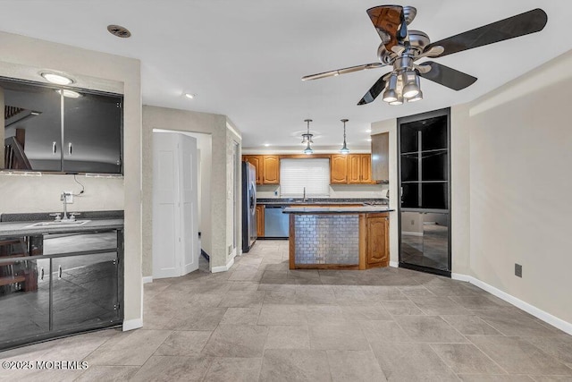 3 Black Pine Ln, Brielle, NJ 08730 - kitchen featuring appliances with stainless steel finishes, a ceiling fan, baseboards, dark countertops, and a sink