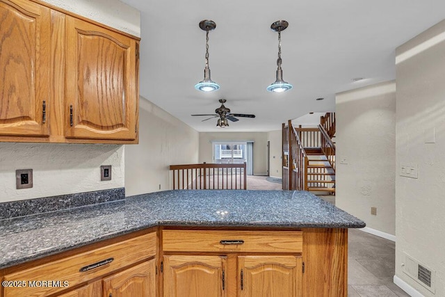 3 Black Pine Ln, Brielle, NJ 08730 - kitchen with a peninsula, ceiling fan, pendant lighting, brown cabinets, and a textured wall