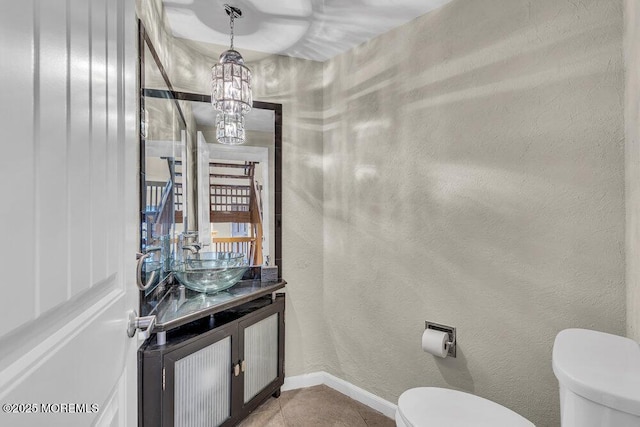 3 Black Pine Ln, Brielle, NJ 08730 - half bathroom with toilet, vanity, baseboards, a chandelier, and tile patterned floors
