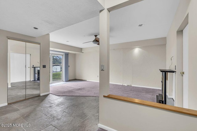 3 Black Pine Ln, Brielle, NJ 08730 - unfurnished room with baseboards, a ceiling fan, stone tile flooring, and carpet floors