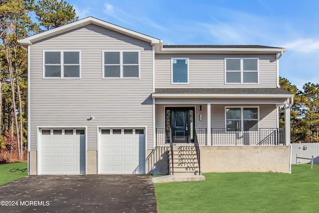 169 Grand Central Pkwy, Bayville, NJ 08721 - view of front of house with an attached garage, driveway, a front lawn, and covered porch