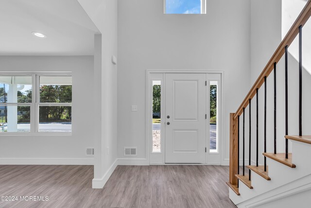 169 Grand Central Pkwy, Bayville, NJ 08721 - foyer entrance with a towering ceiling, stairs, wood finished floors, healthy amount of natural light, and recessed lighting