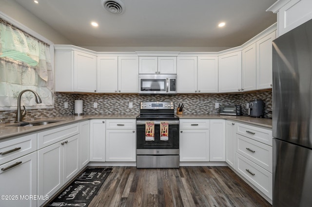 1A Winthrop Pl Unit 55, Whiting, NJ 08759 - kitchen with stainless steel appliances, a sink, white cabinetry, dark wood-style flooring, and recessed lighting