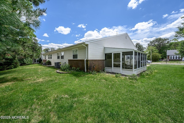 1A Winthrop Pl Unit 55, Whiting, NJ 08759 - rear view of house with a sunroom, brick siding, a yard, and central AC unit