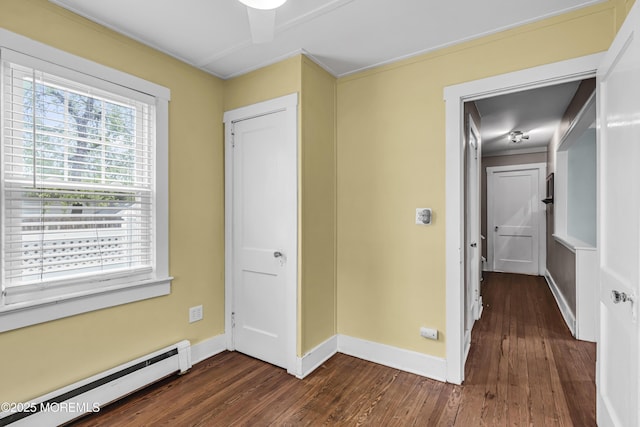 742 Leroy Pl, Lake Como, NJ 07719 - unfurnished bedroom featuring a baseboard radiator, dark wood-type flooring, baseboards, and ornamental molding