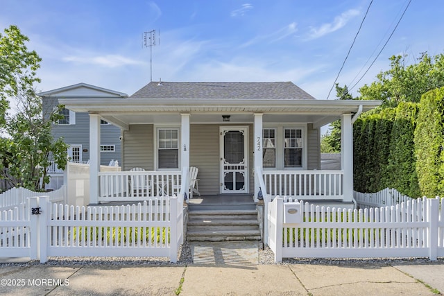 742 Leroy Pl, Lake Como, NJ 07719 - bungalow with covered porch, a shingled roof, and a fenced front yard